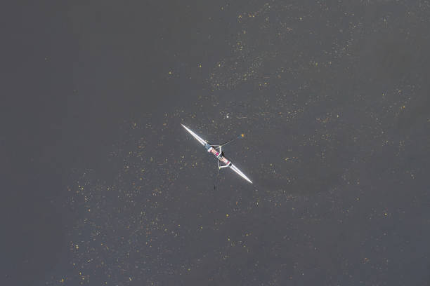 istock Man training on canoe in isolation on the River Clyde 2181230221
