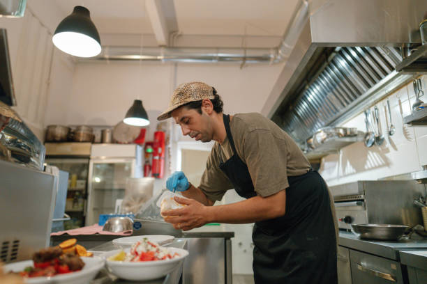 istock Chef prepares the food in a casual restaurant kitchen 2181231096