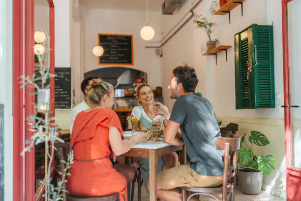 istock Friends are chatting and smiling at a cozy restaurant. 2181231132