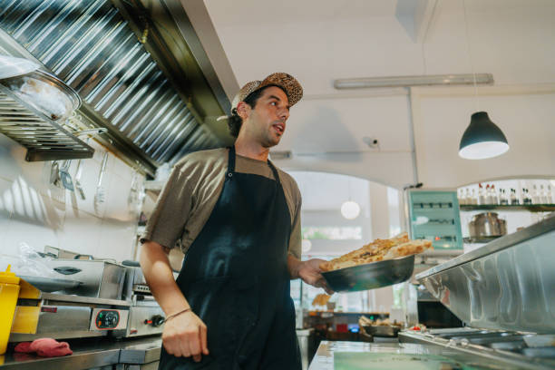 istock Chef prepares the food in a casual restaurant kitchen 2181231143