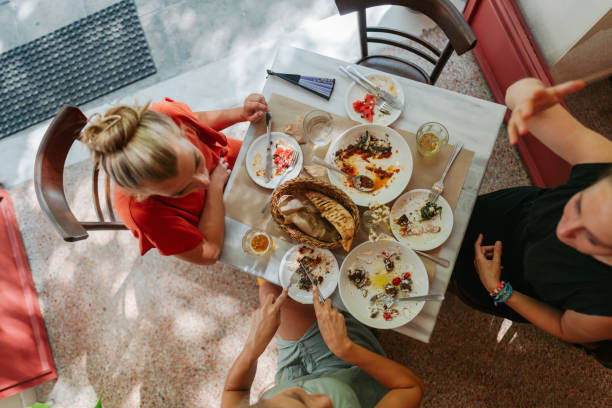 istock Friends happily enjoy their meal together. 2181231185