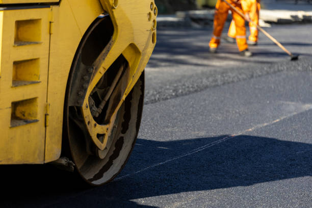 istock Road construction workers applying fresh asphalt in urban area with paving equipment during daytime hours 2181233969