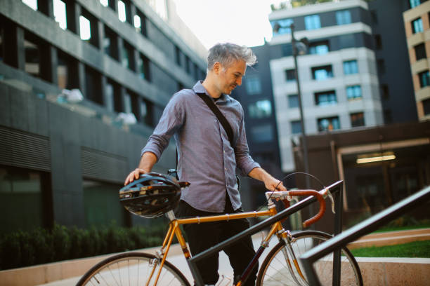 istock man arriving at work, parking his bicycle 2181234232