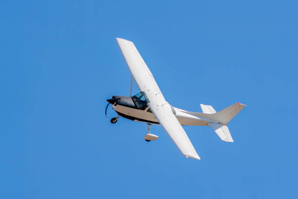 Ultralight plane with prolonge fyling on blue sky. Aviation background
