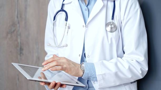 istock Doctor at work. Unrecognizable medical professional using digital tablet showcasing modern medical technology 2181247262