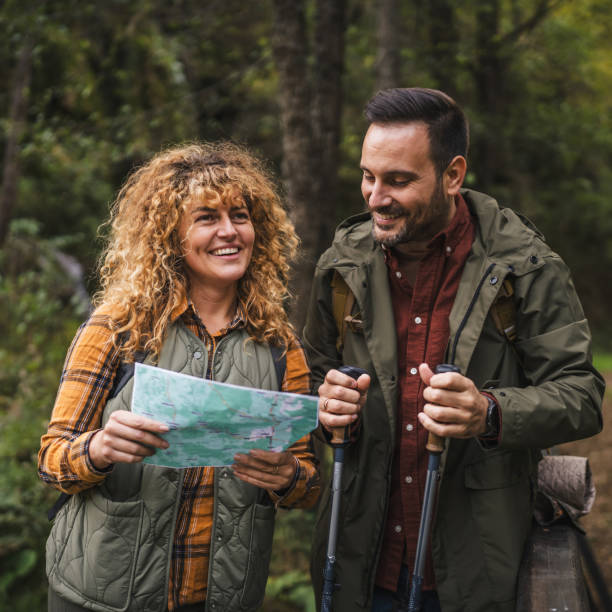istock hiker couple backpackers explore forest and find route on map 2181248841