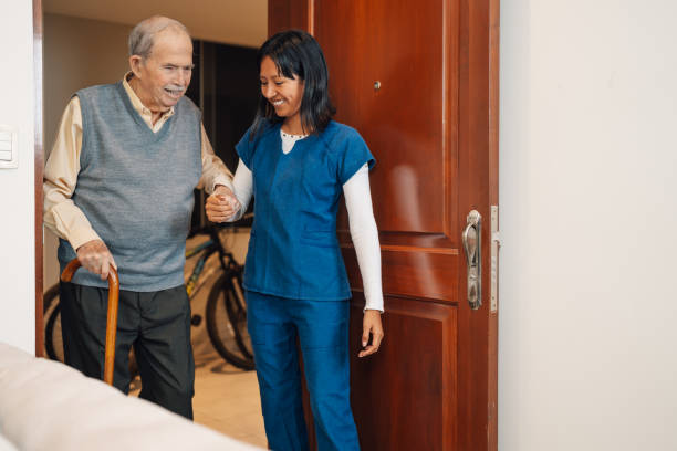 istock Old man assisted by a nurse during a home visit 2181249012