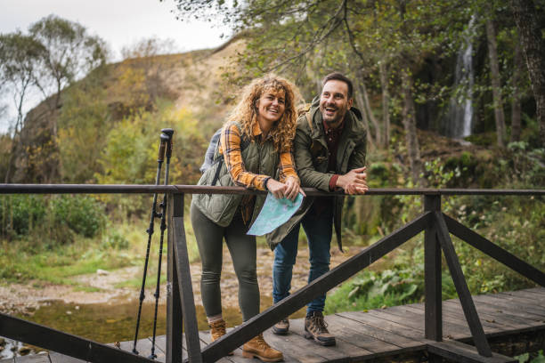 istock couple backpackers on bridge explore forest and find route on map 2181250152