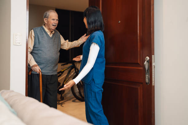 istock Old man greeting a nurse arriving for a home visit 2181250420