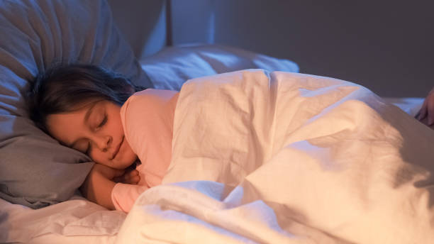 istock Sleeping child night rest small girl lying in bed 2181251344