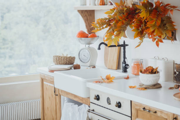 istock Autumn kitchen interior with fresh produce and decorative foliage near a window 2181251916