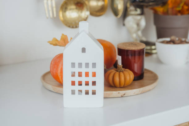 istock Decorative autumn arrangement with pumpkins and a lantern on a kitchen counter 2181251922