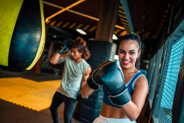 istock Confident Hispanic Female Boxing Training With Teammate 2181252458