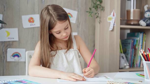 istock Creative child drawing at the desk at home or school class room 2181253121