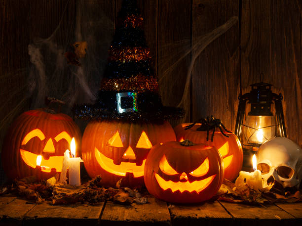 istock Halloween Jack-o-Lantern Pumpkins on rustic wooden background 2181263499