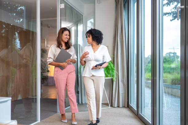 istock Diverse Businesswomen Collaborating in Office Walkway 2181263715