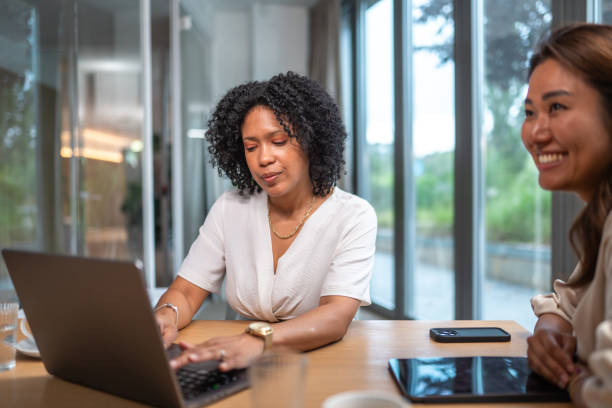 istock Diverse Businesswomen Collaborating in Office Setting 2181263741