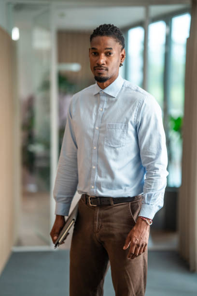 istock Confident Black Businessman with Tablet in Office Hallway 2181263796