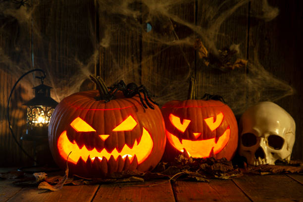 istock Halloween Jack-o-Lantern Pumpkins on rustic wooden background 2181263830
