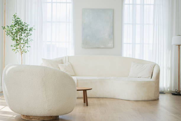 istock Stylish loft bedroom interior. Spacious design apartment with light walls large windows white couch sofa and armchair. Clean modern decoration with elegant furniture in minimalist Scandinavian style. 2181264308