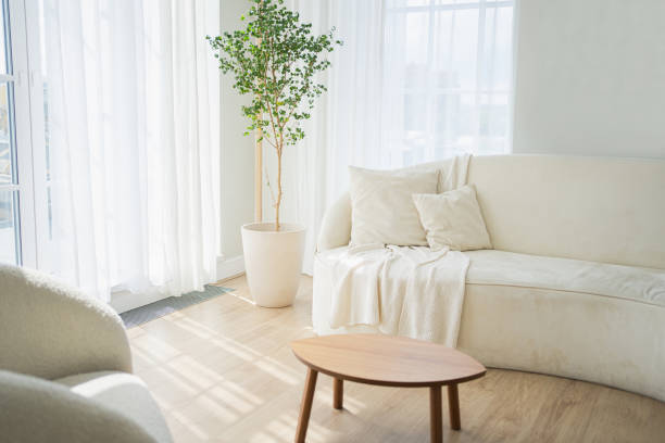 istock Stylish loft bedroom interior. Spacious design apartment with light walls large windows white couch sofa and armchair. Clean modern decoration with elegant furniture in minimalist Scandinavian style. 2181264309