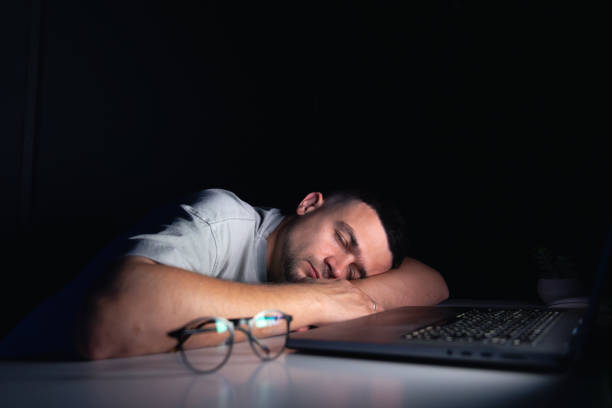istock Young man works at the computer at night. 2181264898