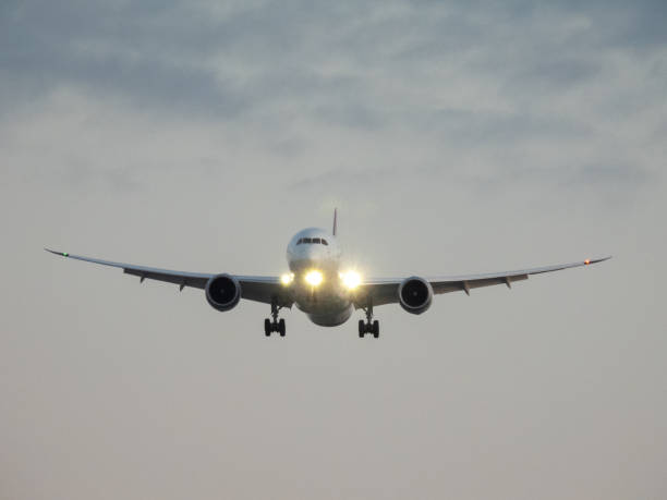 A Qantas Boeing B787-9 plane, registration VH-ZNL, coming into land at Sydney Kingsford-Smith Airport as flight QF8 from Dallas. This image was taken from the 10th floor roof of a public carpark at the domestic terminal on a sunny and cold morning at sunrise on 26 October 2024.