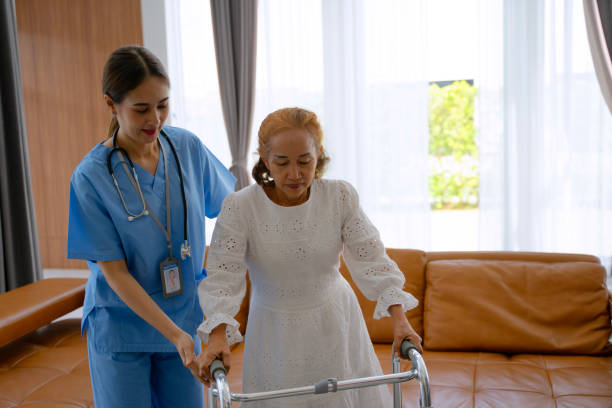istock Nurse is take care senior woman at home. Using walker. 2181277101