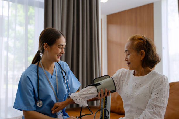 istock Nurse is take care senior woman at home. Using stethoscope. 2181277150