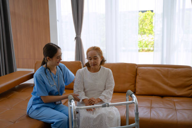 istock Nurse is take care senior woman at home. Using walker. 2181277174