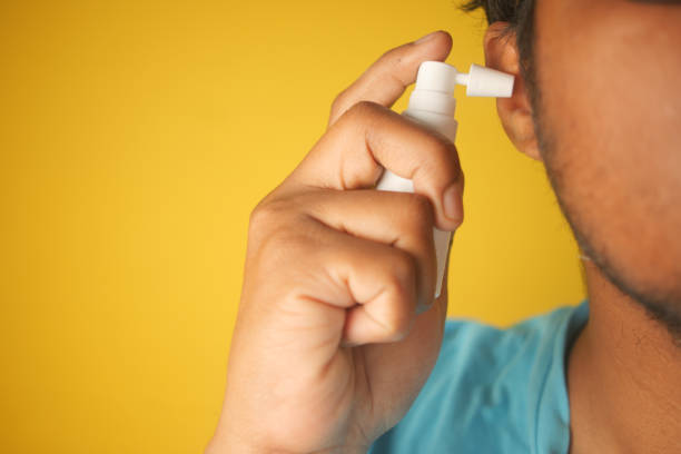 istock Close up of men using spray to remove earwax 2181278074