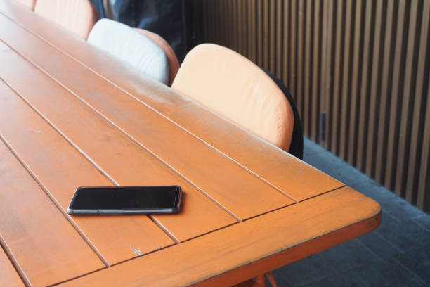 istock A Modern Workspace Featuring a Smartphone Resting on a Wooden Table Surface in an Office Setting 2181278484