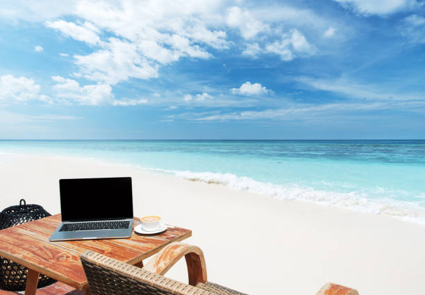 istock Mobile work office on the tropical paradise beach with blank laptop screen 2181283014