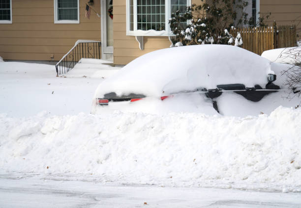 Car on the driveway buried in snow after blizzard