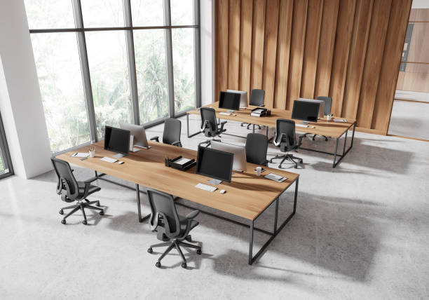 istock Top view of office workspace interior with pc computers on desk near window 2181288257