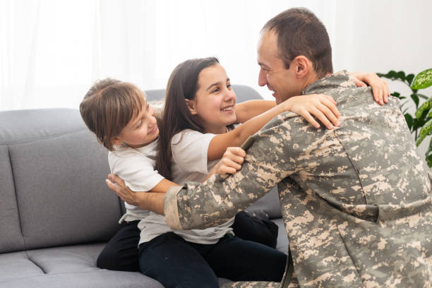 istock military father and two daughters at home 2181288444