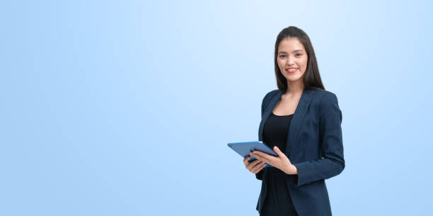 istock Asian woman with tablet in hands, smiling portrait on empty background 2181288609