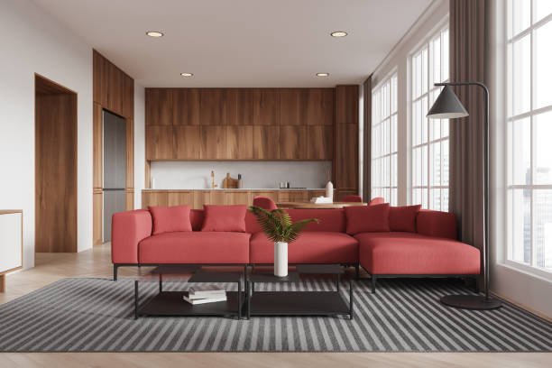 istock Modern living room with red sofa, wooden kitchen in background. 3D Rendering 2181288650