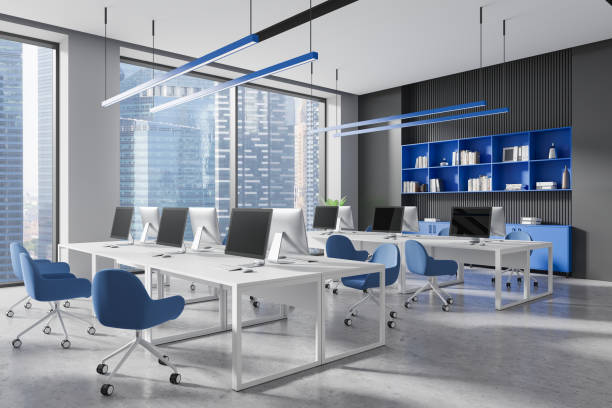 istock Colored coworking interior with tables and pc monitors, panoramic window 2181288685