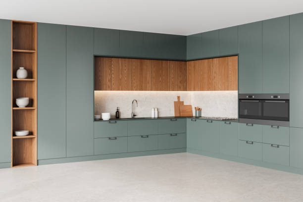 istock Modern kitchen interior with green cabinets and wood finishes, featuring a clean design. The kitchen includes open shelves and built-in appliances, highlighting luxury and functionality. 3D Rendering 2181288701
