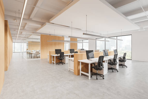 istock Modern open-space office interior featuring wooden partitions, ergonomic chairs, and large windows. Bright and spacious with a city view. Concept of coworking space. 3D Rendering 2181290737