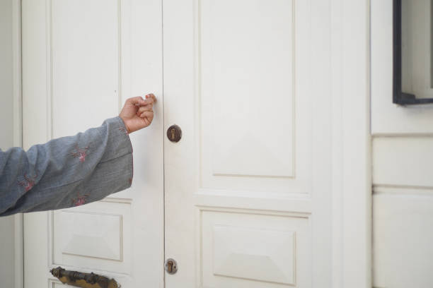 istock women hand knock the door 2181291005