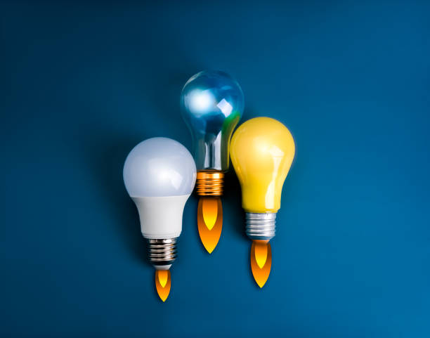 istock Business and innovation compete, creative idea, inspiration, education knowledge and learning, startup concept. 3 lightbulbs with fire smoke graphic as spaceship or rocket launch on blue background. 2181291551