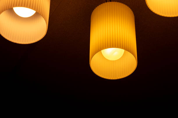 A ceiling light fixture that illuminates the room with orange light