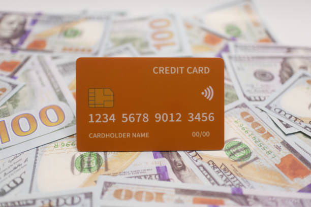 istock Orange Credit Card on Spread of US  Bills. 2181300411