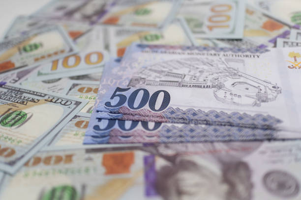 istock Blue Riyal Bills on US Dollar Background. 2181300443