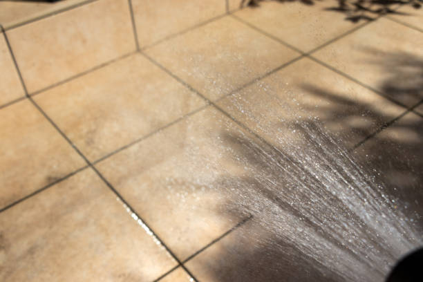 istock Sprinkling water from the shower on the tiled terrace 2181301426
