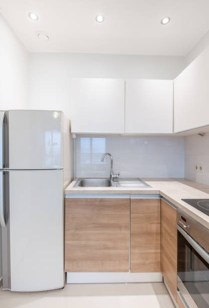 istock Scandinavian Style Cozy Modern Open Bright Kitchen Home Interior. Faucet, Oven, Fridge and Furniture in Background. 2181305416
