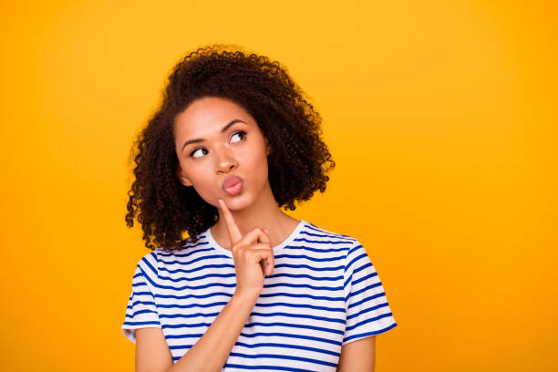 istock Photo of minded creative lady finger touch chin pouted lips look empty space hmm deep isolated on yellow color background 2181306475