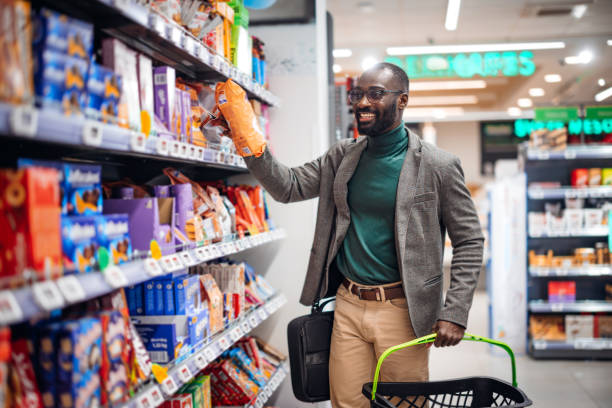 istock Man Shopping for Snacks in a Modern Grocery Store 2181313003
